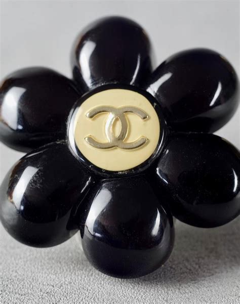 chanel black camellia ring|Chanel camellia brooches.